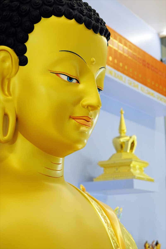 buddha statue with stupa in the background