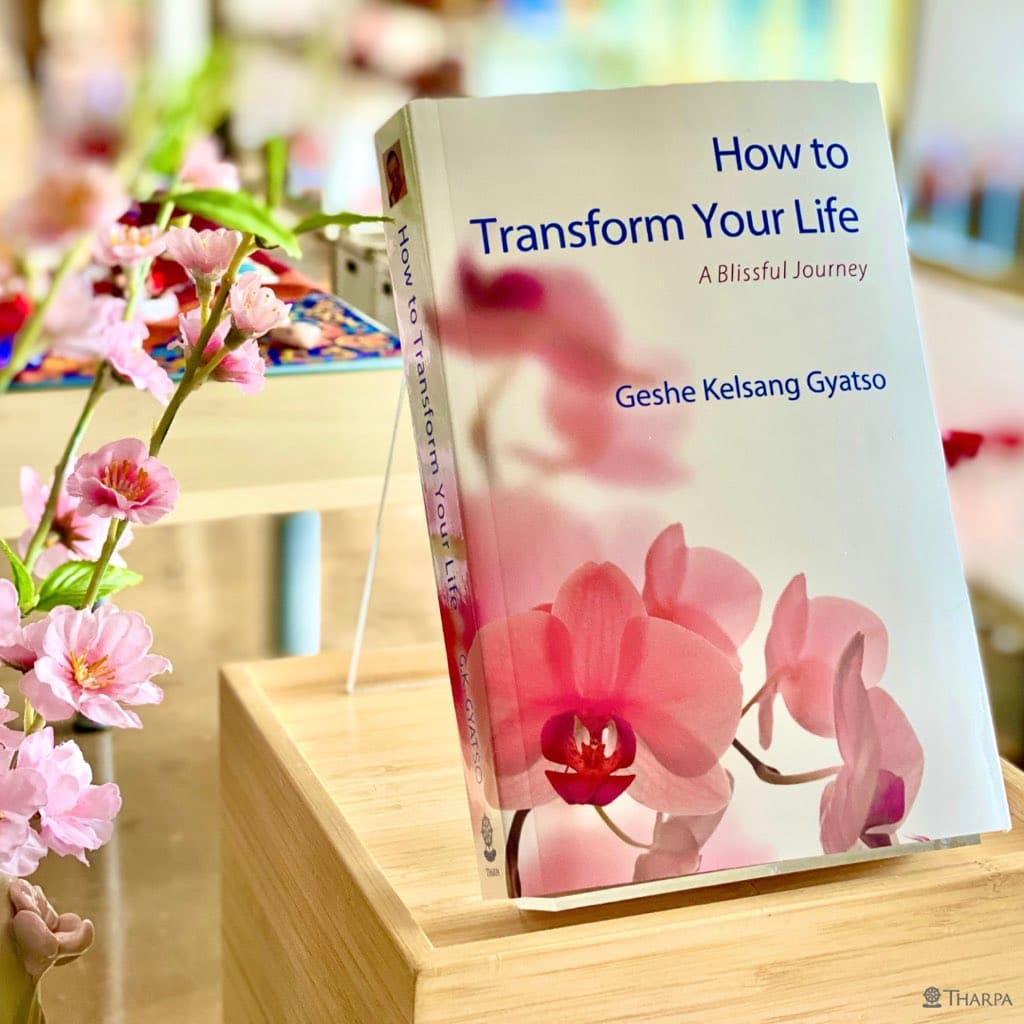 paperback of How to Transform Your Life book with flowers