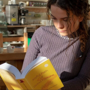 Lady reading Joyful Path of Good Fortune